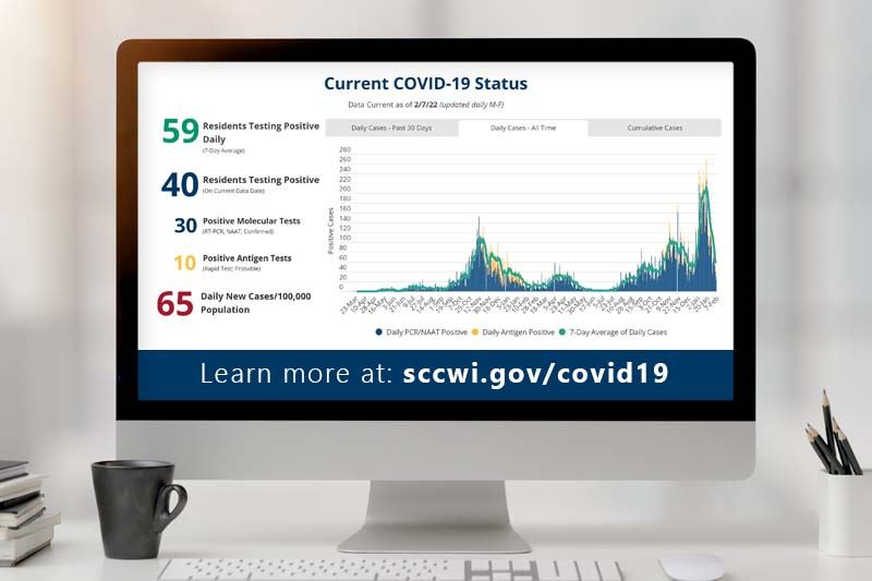 A computer with the St. Croix County COVID-19 Dashboard on the screen.
