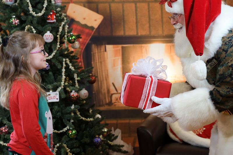 Santa giving a little girl a gift.