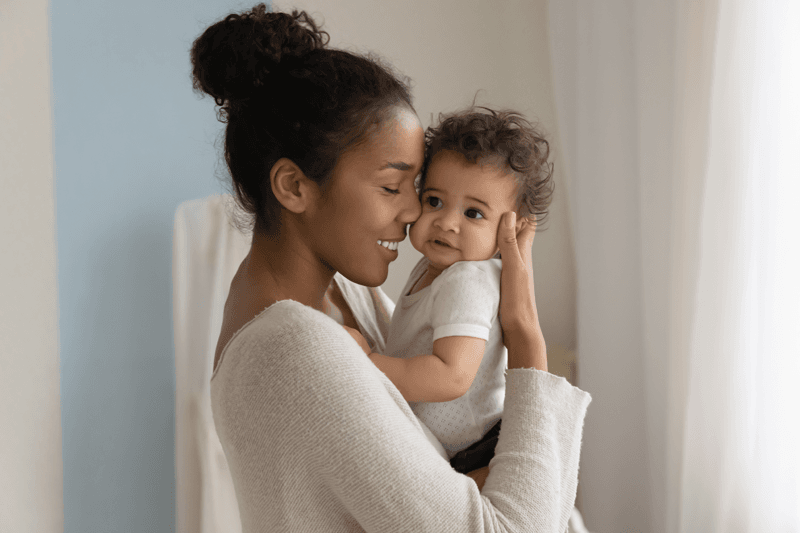 A woman holding a baby. 