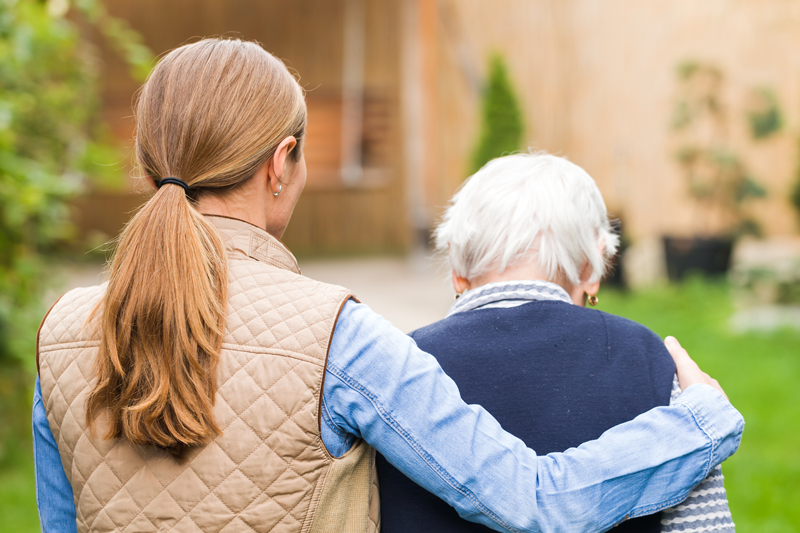 A younger and elderly woman walking.