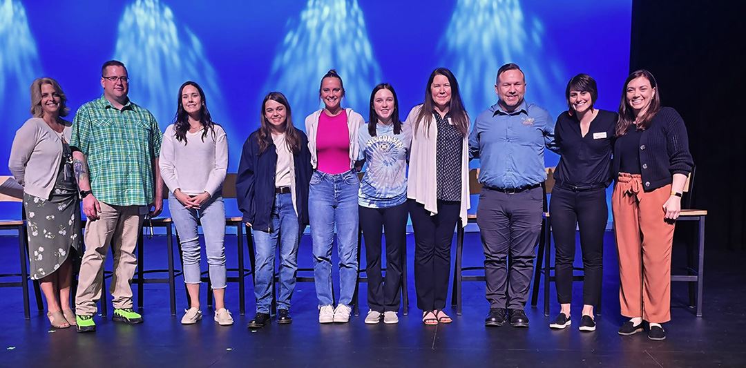 Presenters standing on stage at St. Croix County's Mental Health Symposium.