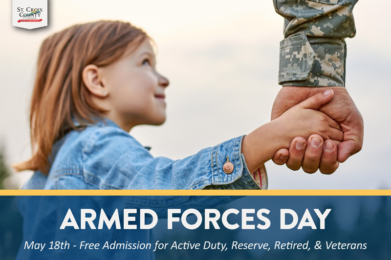 A girl holding the hand of a member of the military.