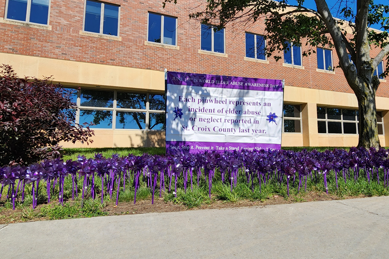 Banner and pinwheels set up for world elder abuse awareness day.