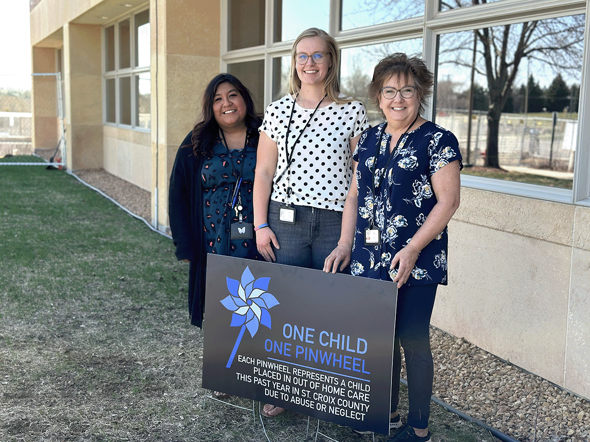 St. Croix County employees standing in front of a banner for family strengthening month